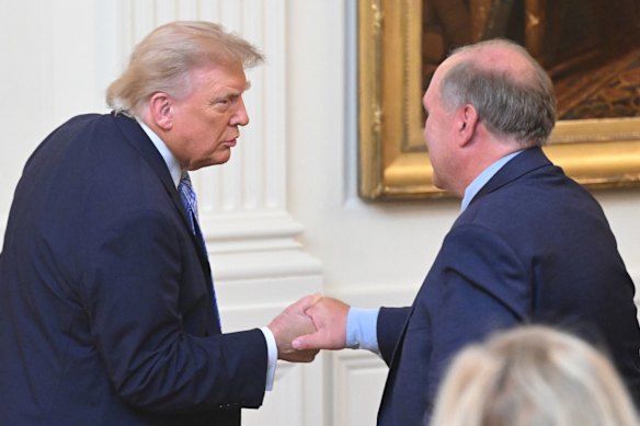 Trump and journalist John Solomon shake hands in the East Room of the White House on Thursday night (Washington time).