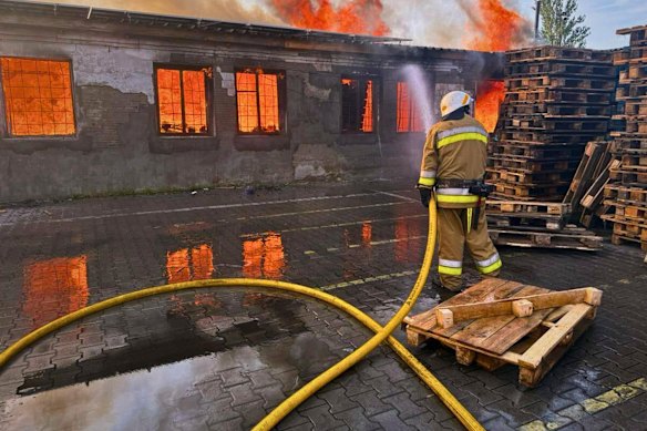 A firefighter puts out a fire near Kyiv on Wednesday following a Russian overnight attack.
