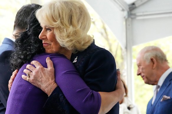 The Queen embraces a relative of a victim of the 9/11 attacks at the memorial.