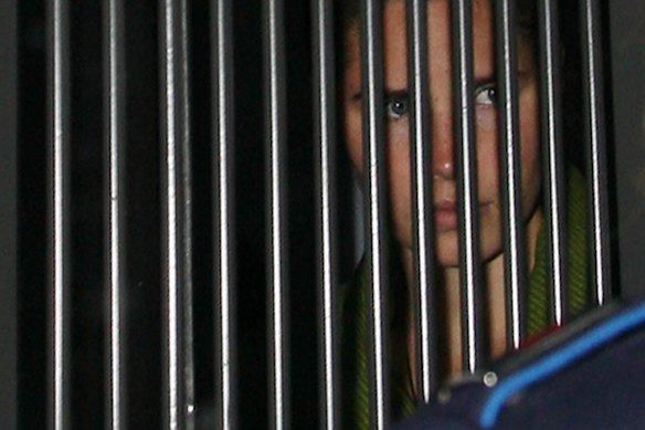 Knox in 2009, being driven in a police van to hear the sentence in the murder trial.
