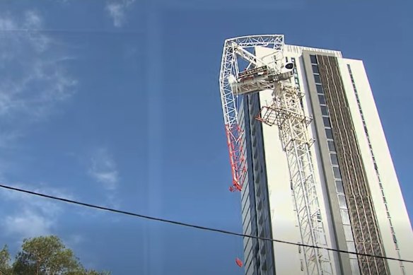 Police declared an emergency zone after a freak storm smashed the central Gold Coast, snapping a crane in half.