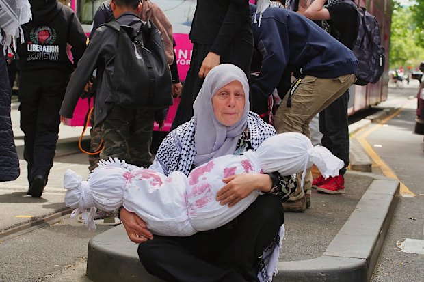 A Melbourne protester at a rally last year holding an effigy intended to symbolise a slain Palestinian child.