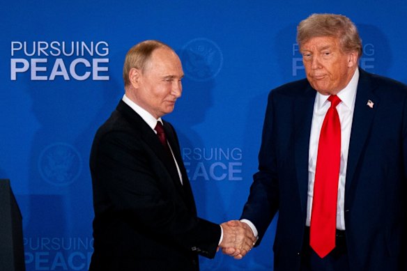 US President Donald Trump shakes hands with Russian President Vladimir Putin.