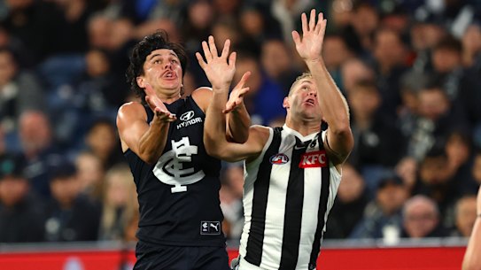 Hollands competes against Collingwood’s Dan Houston for the ball.