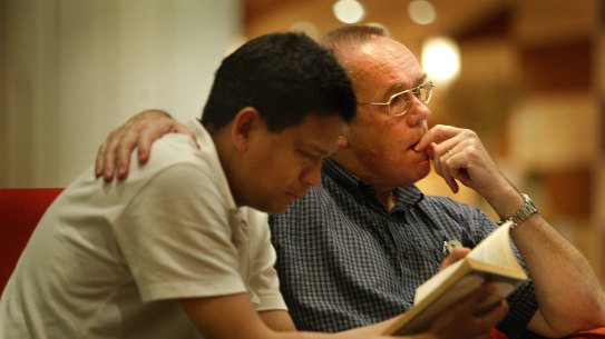  Barrister Joseph Thesiera and Lex Lasry become emotional as they read through some of the material from a box of executed Australian man Nguyen Tuong Van in 2005. 