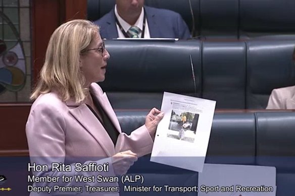 Rita Saffioti holding up her Sandra Brewer flipchart of old tweets.