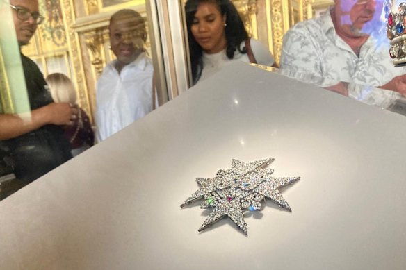 Visitors look at fine jewellery in the Louvre Museum in September.