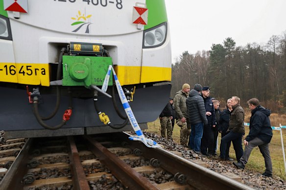 Prime Minister Donald Tusk, second right, inspects the rail line at Mika that was damaged by sabotage.
