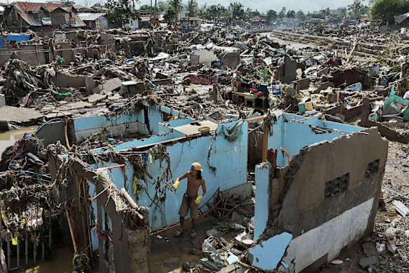 A resident returns to what remains of a home after Typhoon Kalmaegi devastated communities in Talisay, Philippines, this month.