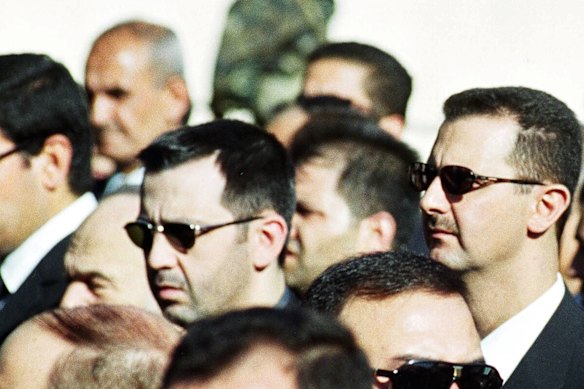 Bashar Assad, right, and his brother Maher, centre, in Damascus in 2000.