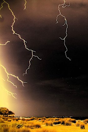 Tongues of dry lightning light up the beach at Portland soon after midnight Friday.