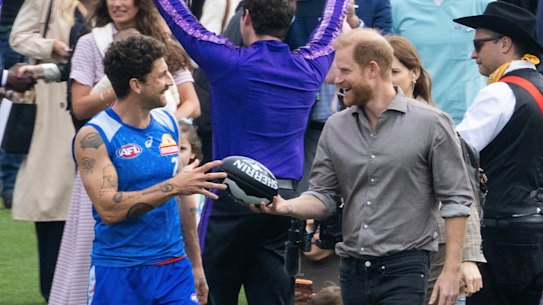Tom Liberatore teaches Harry about Australian rules football.