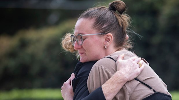 Outside the NSW Coroner’s Court at Lidcombe, Lisa Jokinen embraces her late father’s partner.