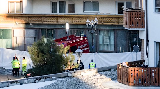 Police officers inspect the bar at which a fire broke out amid New Year’s celebrations.