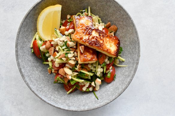 Simple ingredients star in this salad, which tops pearl couscous, zucchini and almonds with golden halloumi.