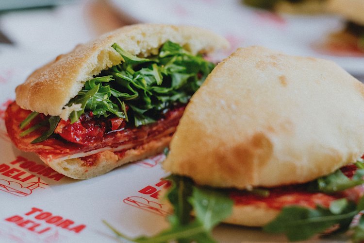 A house-baked puccia with hot salami, provolone, semi-dried tomatoes, rocket and chilli at Tooradeli.