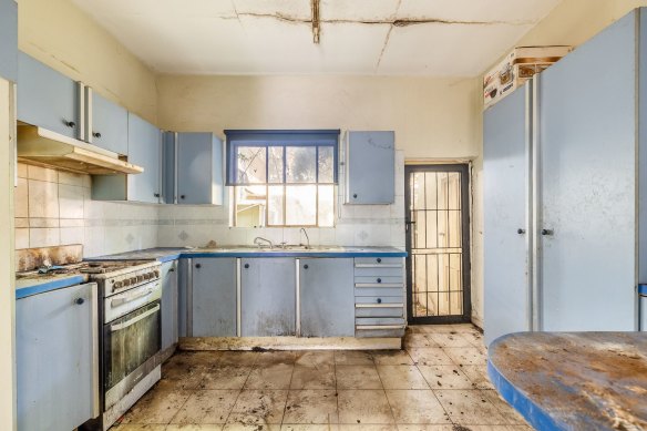 A dilapidated Redfern terrace sold for $1.35 million at auction on Saturday to a builder.