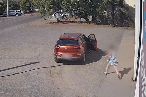 A woman rushes to her car after it is stolen by a 15-year-old boy in Kalgoorlie while her son is inside. The teenager was jailed over the car theft on Monday.