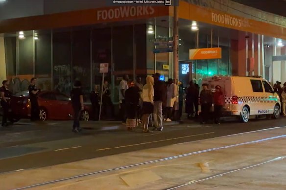 Police and onlookers at the scene of the shooting in the early hours of Saturday morning.
