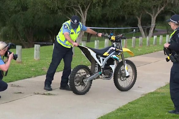 Police examine an electric off-road motorbike involved in a fatal crash in Edgewater on Saturday.