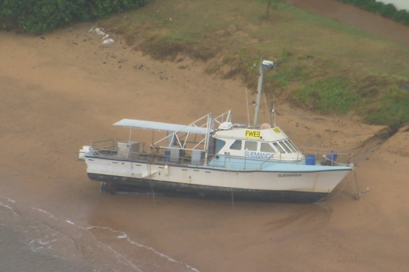 A boat washes ashore in Moreton Bay.