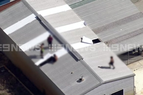 Youths on the roof of Banksia Hill on Monday. 