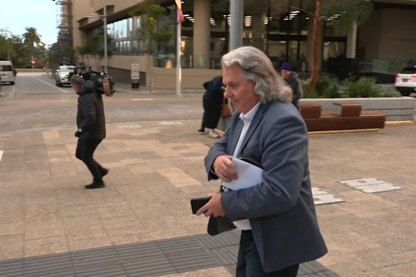 Chris Marco makes his way to court through waiting media during the first week of his trial.