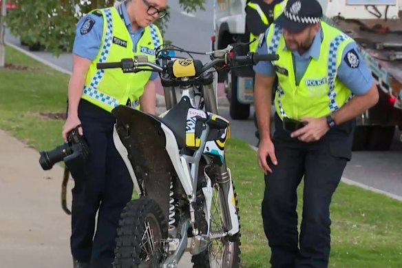 Police examine an electric off-road motorbike involved in a fatal crash in Edgewater.