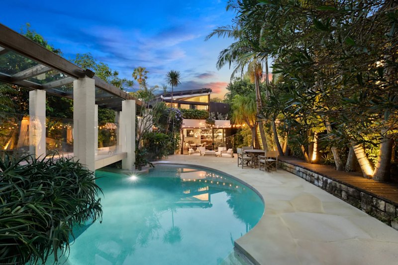 Mechanics Carmen and Steve Davidson are offloading their Vaucluse mansion, which has a stone walkway above the pool.
