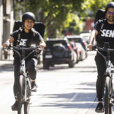 Delivery riders Mariella Bagang and Chintan Mewada work for Send in Melbourne. Unlike gig economy riders, they enjoy traditional employment.