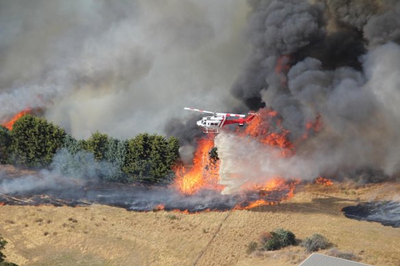 A firefighting helicopter battles the Longwood, Victoria bushfire on Thursday.