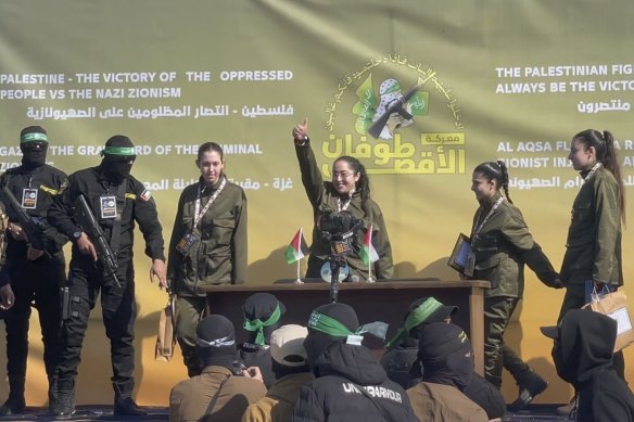 In this image taken from an Associated Press video, Israeli female soldier hostages wave at a Palestinian crowd before being handed over to the Red Cross in Gaza City on Saturday.