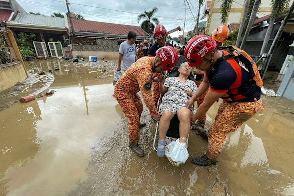 Fire crews rescue a person from flooding in Cebu City.