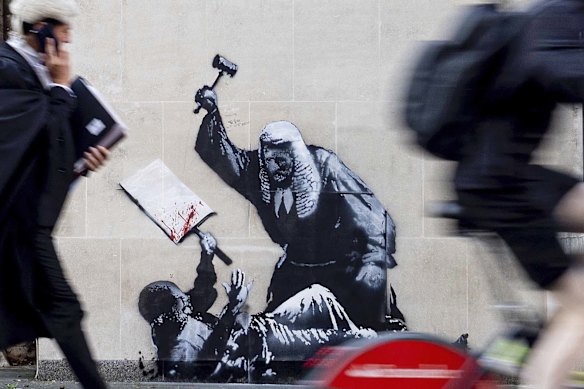 A new Banksy artwork portrays a judge beating a protester with a gavel at the Royal Courts of Justice in London. 