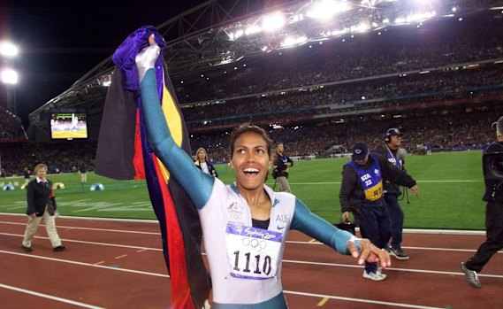 Cathy Freeman on her victory lap at the 2000 Olympic Games, flourishing both the national and Aboriginal flags. 