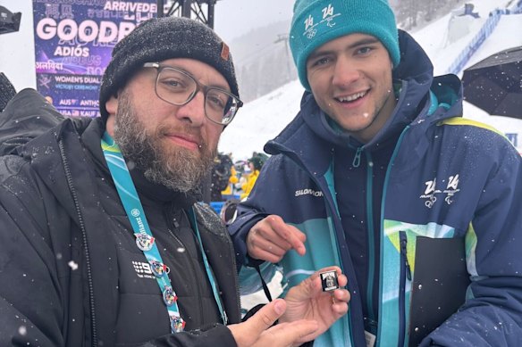 Reporter Vince Rugari trades pins with an Olympic official.