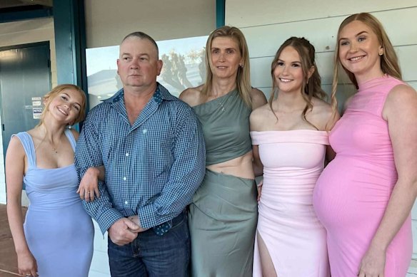 Cody Gallagher (left) with her family before her formal.
