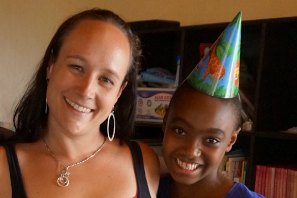 Carley Mchome, left, pictured with children’s home resident Irene, around 2012.