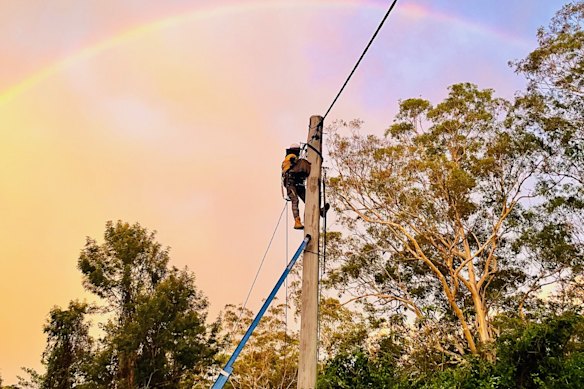 An Energex technician working to restore power after the 2023 Christmas storm on the Gold Coast.