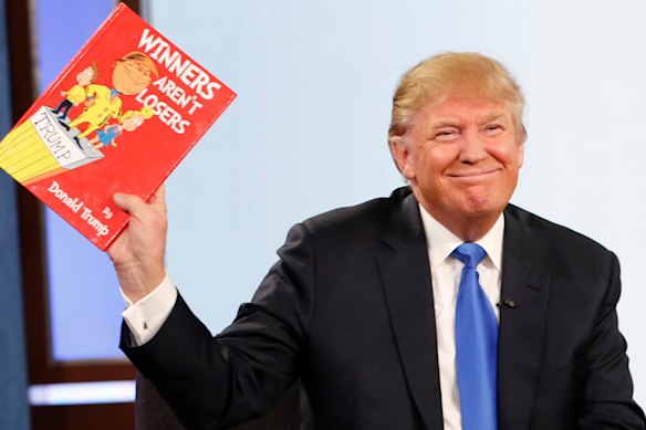 Donald Trump isn’t often pictured holding a book, but during the 2015 presidential campaign holds a Dr Seuss-style book written to imitate his style on Jimmy Kimmel Live.