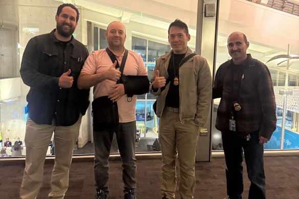 Bondi hero Ahmed al Ahmed with an FBI escort at Los Angeles airport.