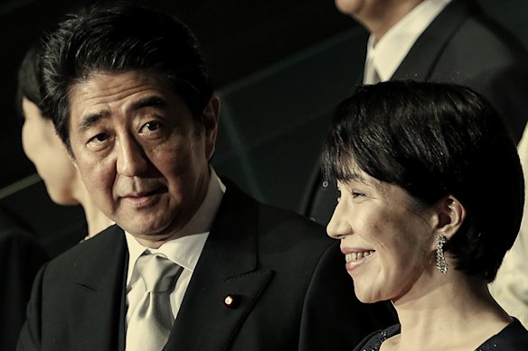 Takaichi with then PM Shinzo Abe, centre, in 2014. She has taken a leaf from his economic policies.