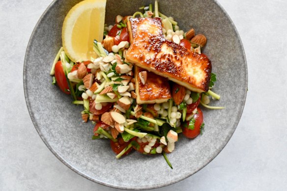 Simple ingredients star in this salad, which tops pearl couscous, zucchini and almonds with golden halloumi.