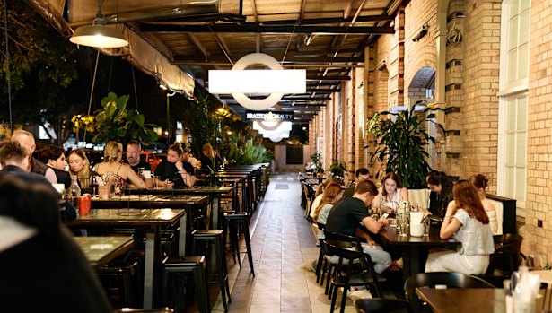 Diners at one of the restaurants along Vernon Terrace, below the converted woolstores in Teneriffe. 