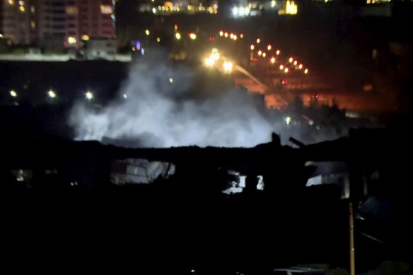 This image taken from video provided by Rudaw TV shows smoke rising from a building hit by a strike in Irbil, Iraq, on January 16.