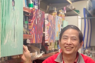 Peter Jia in his shop with his art.