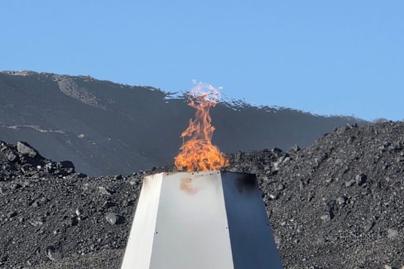 Flaring at TMK Energy’s Lucky Fox 4 gas well adjacent to a coal stockpile in Mongolia.