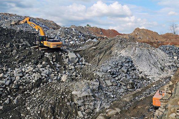Earth moving equipment being used for artisanal mining activities at the Fonlo project in Nigeria.