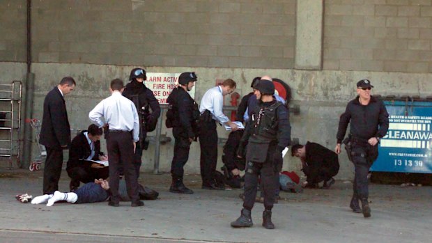 The Veteran’s arrest by Special Operations Group police officers. White socks with long pants is not a good look.