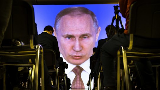 Stocking up on gold: Journalists watch as Vladimir Putin gives his annual state of the nation address.